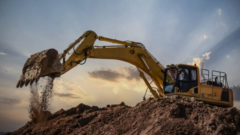 Image of an excavator dumping dirt